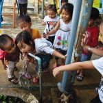 Kids in the community enjoying clean drinking water. Who wouldn't right?